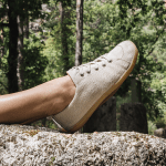 Outstretched eg from the side, in nature setting. They are wearing Mukishoes SAND